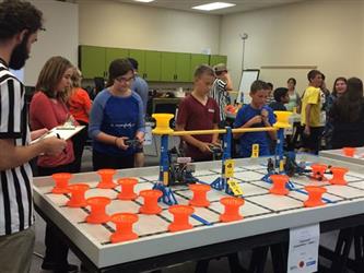 Students competing in a robotics competition. 